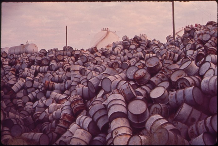 A_MOUNTAIN_OF_DAMAGED_OIL_DRUMS_NEAR_THE_EXXON_REFINERY_-_NARA_-_546000